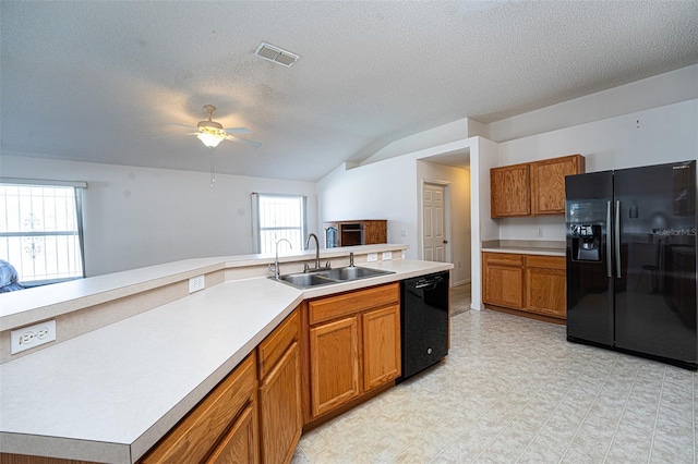 kitchen featuring lofted ceiling, sink, ceiling fan, black appliances, and a textured ceiling