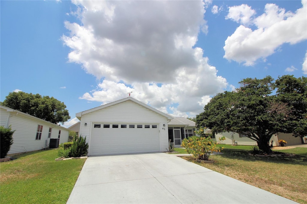 ranch-style home with a garage, driveway, central AC unit, and a front lawn