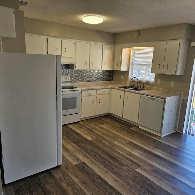 kitchen with white cabinetry, sink, dark wood-type flooring, and white appliances