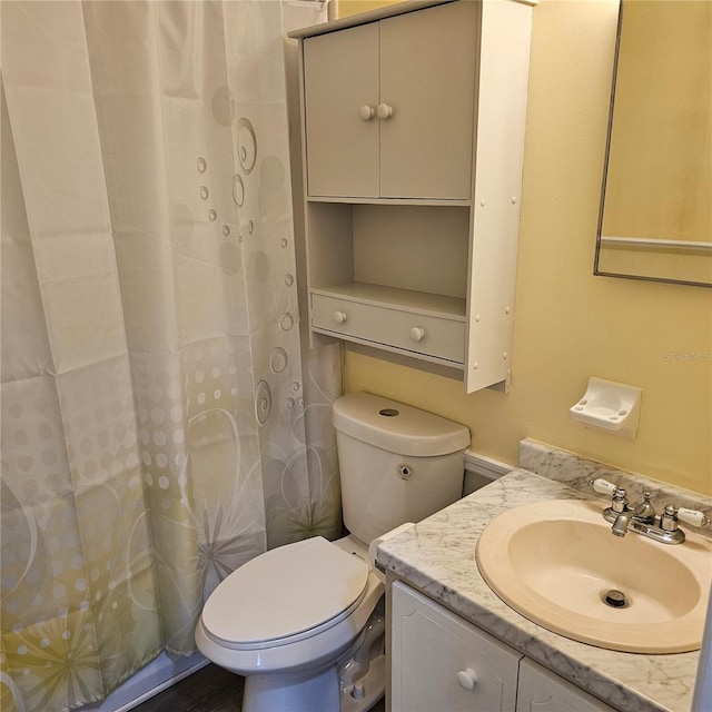 bathroom featuring vanity and toilet