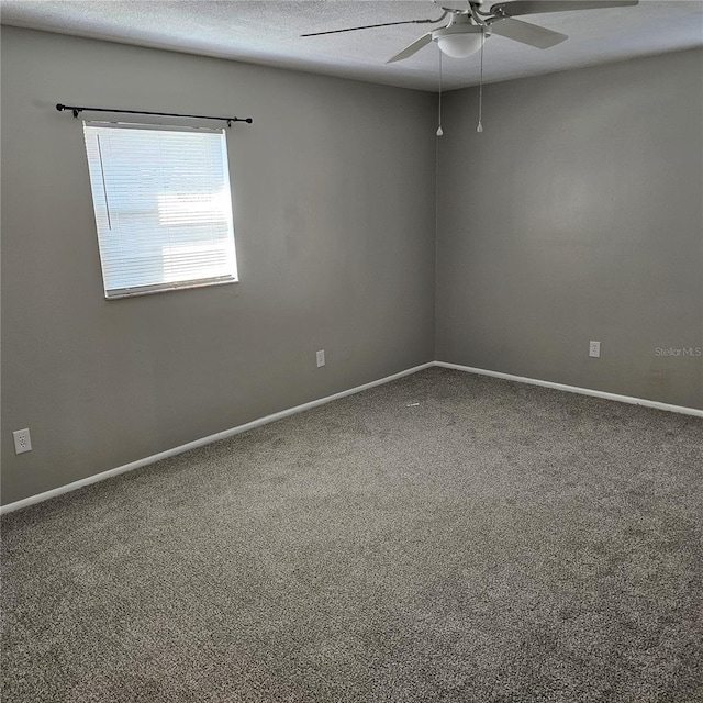 empty room featuring carpet floors, a textured ceiling, and ceiling fan