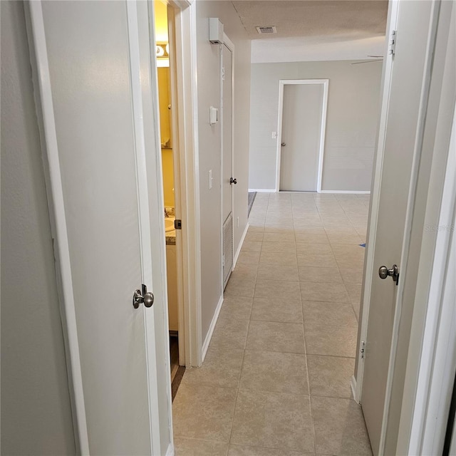 hall with light tile patterned floors