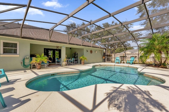 view of swimming pool featuring a lanai, a patio area, and french doors