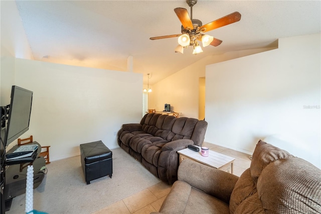 tiled living room with vaulted ceiling and ceiling fan with notable chandelier