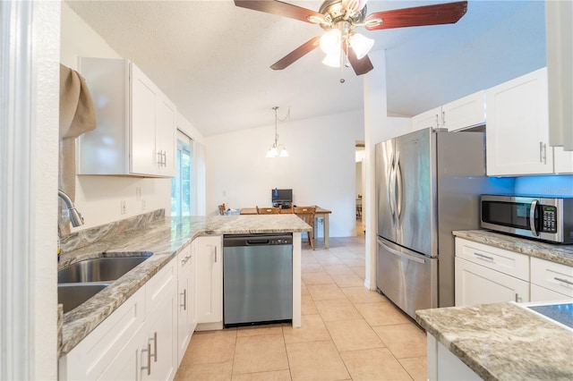 kitchen featuring sink, appliances with stainless steel finishes, white cabinetry, hanging light fixtures, and kitchen peninsula