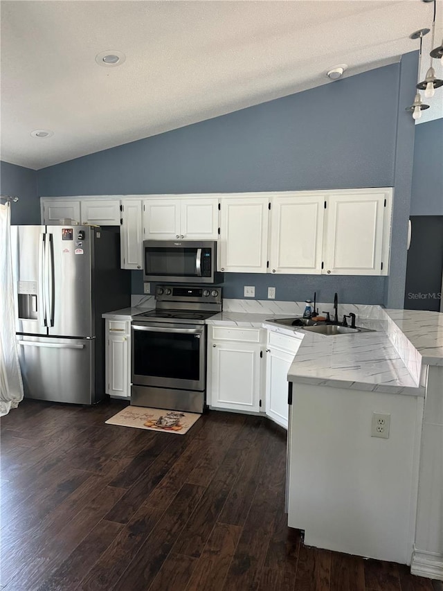 kitchen with lofted ceiling, sink, dark hardwood / wood-style flooring, stainless steel appliances, and white cabinets