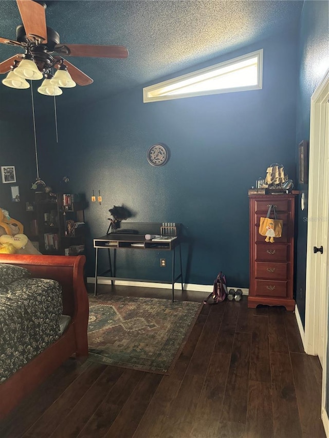 bedroom featuring ceiling fan, dark hardwood / wood-style flooring, and a textured ceiling