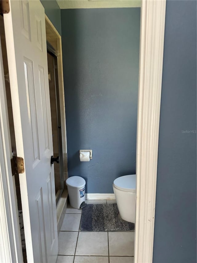 bathroom with tile patterned floors and toilet