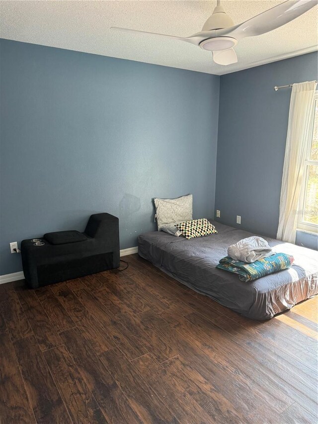 bedroom featuring dark wood-type flooring and a textured ceiling