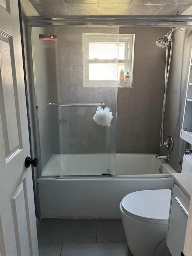 full bathroom with vanity, tile patterned floors, toilet, and combined bath / shower with glass door