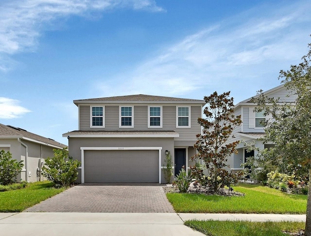 front facade with a garage and a front lawn