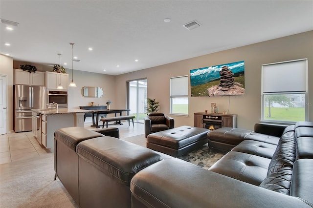 living room with sink and light tile patterned floors