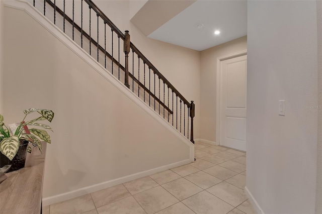 staircase featuring tile patterned floors