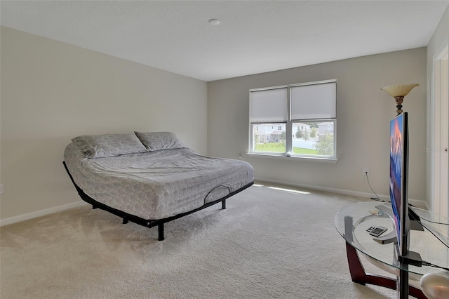 bedroom featuring light carpet