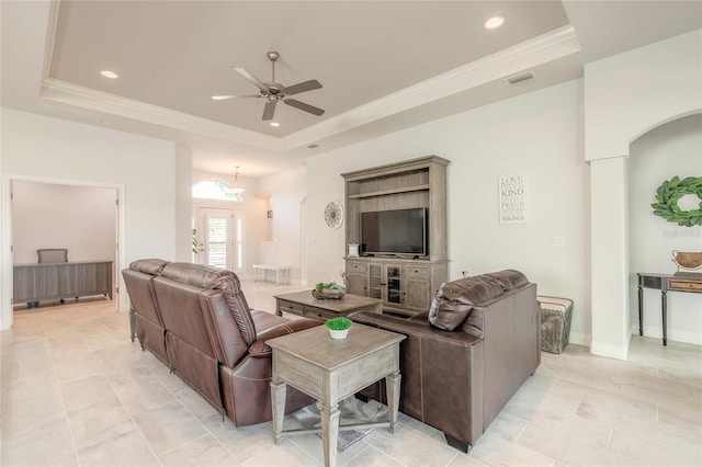 living room with crown molding, a raised ceiling, ceiling fan, and light tile patterned flooring