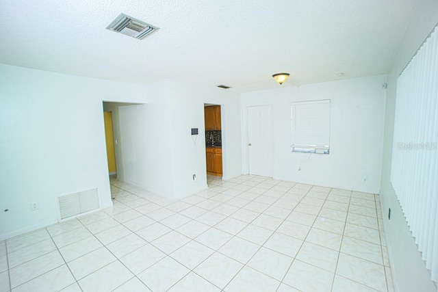 empty room featuring a textured ceiling