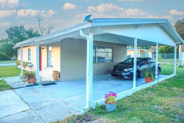 view of parking featuring a yard and a carport