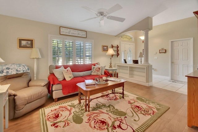 living room with vaulted ceiling, decorative columns, light hardwood / wood-style floors, and ceiling fan