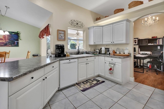 kitchen with white cabinetry, white dishwasher, and kitchen peninsula