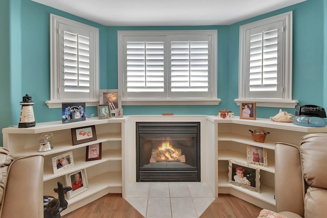 living area with light hardwood / wood-style floors and a wealth of natural light