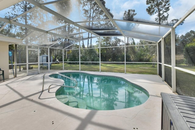 view of swimming pool featuring a storage shed, a lanai, a patio, and a lawn