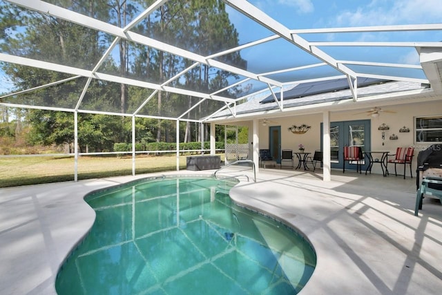 view of pool featuring a lanai, a patio area, and ceiling fan