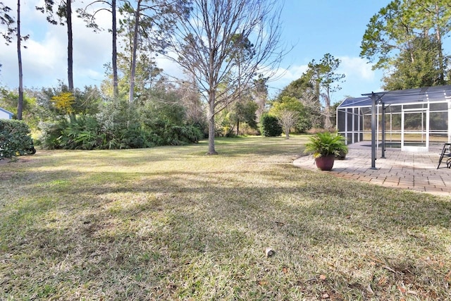 view of yard with a patio and glass enclosure