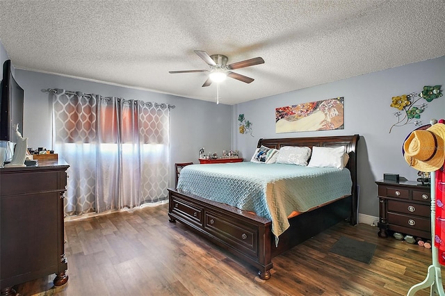 bedroom featuring a textured ceiling, dark wood-type flooring, and ceiling fan