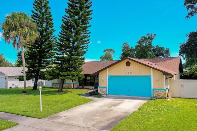 view of front of house with a garage and a front yard