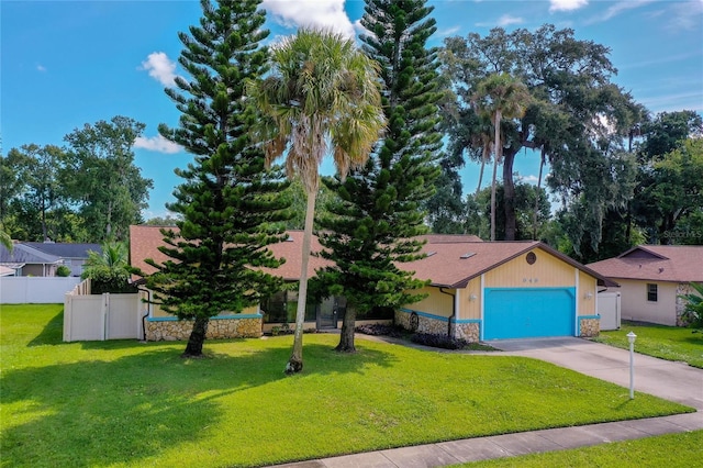 view of front of house featuring a garage and a front lawn