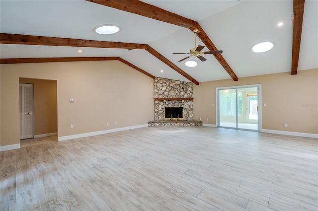 unfurnished living room featuring lofted ceiling with beams, ceiling fan, a fireplace, and light hardwood / wood-style floors