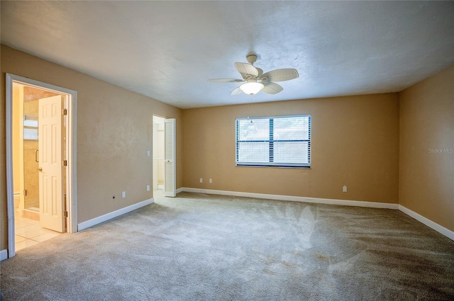 empty room featuring light carpet and ceiling fan