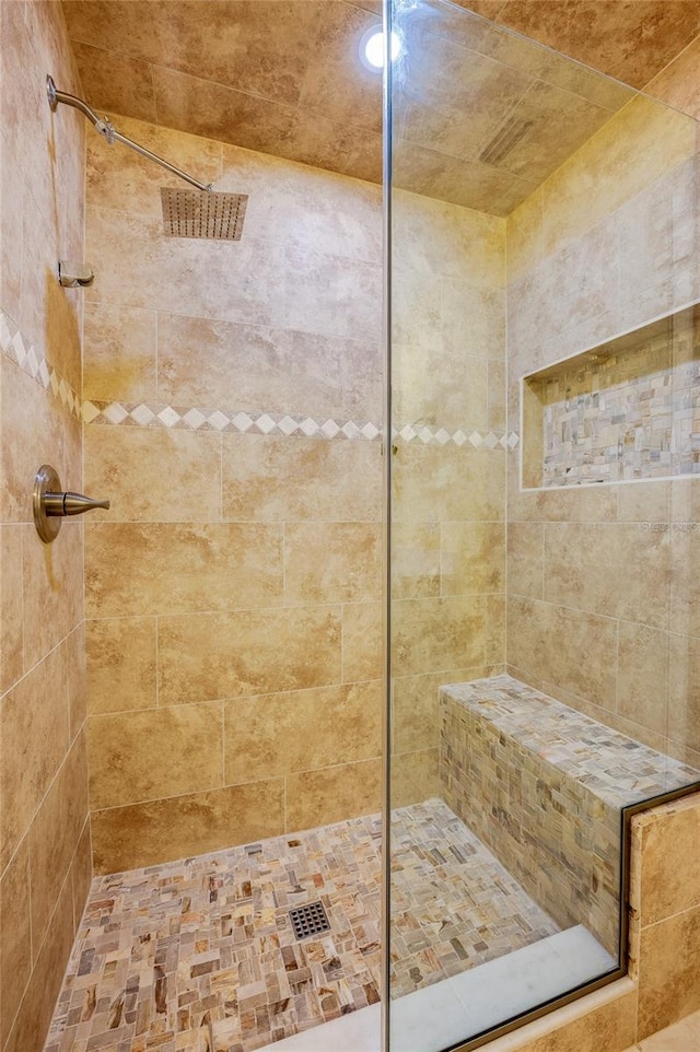 bathroom with tiled shower