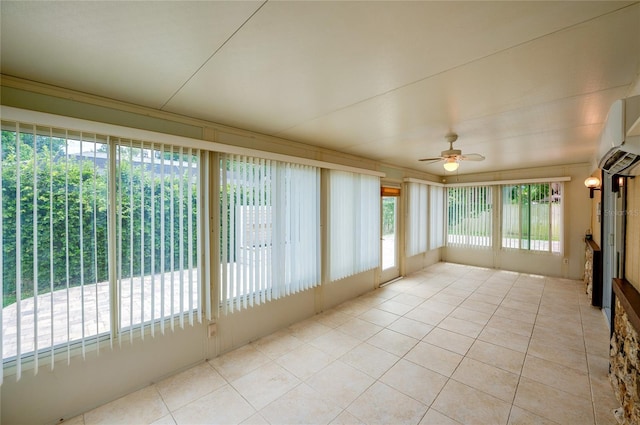 unfurnished sunroom with a wealth of natural light and ceiling fan