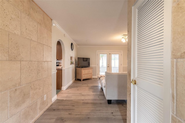 hall featuring hardwood / wood-style floors and crown molding