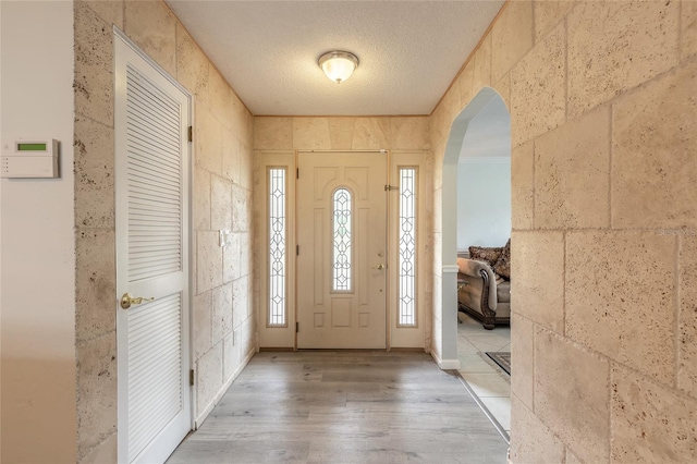 foyer featuring hardwood / wood-style flooring and a textured ceiling