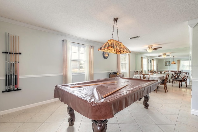 recreation room with ceiling fan, plenty of natural light, light tile patterned floors, and ornamental molding