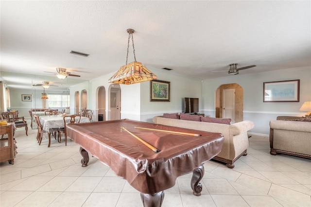 rec room featuring light tile patterned flooring, crown molding, a textured ceiling, and ceiling fan