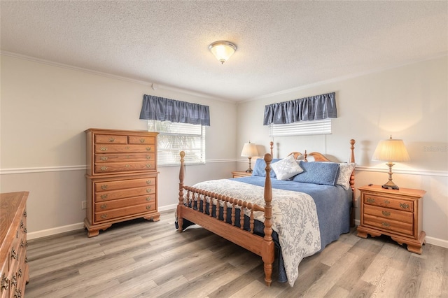 bedroom with hardwood / wood-style floors and a textured ceiling