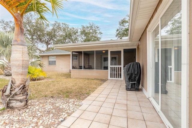 back of property featuring a sunroom and a patio area