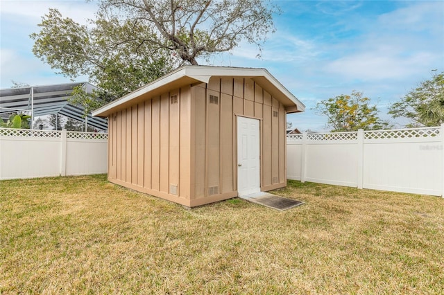 view of outbuilding featuring a yard