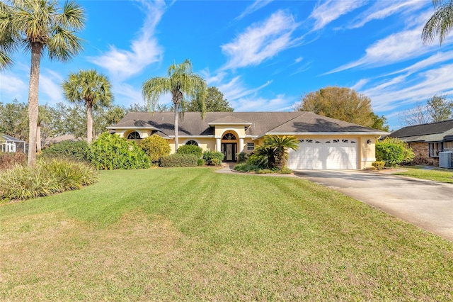 ranch-style house featuring a garage, central AC, and a front lawn