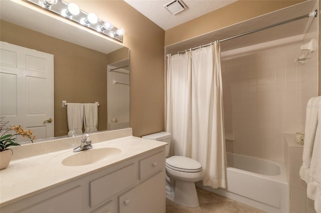 full bathroom with shower / bath combination with curtain, vanity, toilet, tile patterned floors, and a textured ceiling