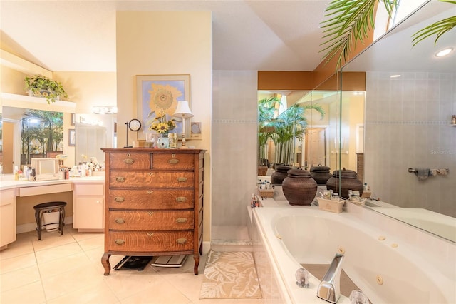 bathroom with vanity, tile patterned flooring, and tiled tub