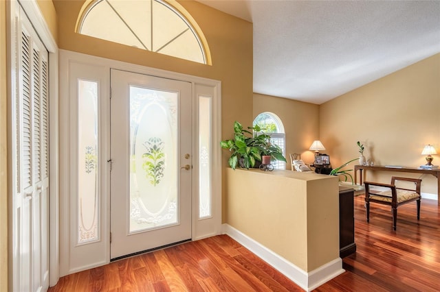 foyer with wood-type flooring and a textured ceiling