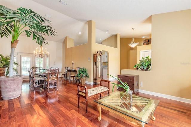 interior space featuring hardwood / wood-style flooring, an inviting chandelier, and high vaulted ceiling