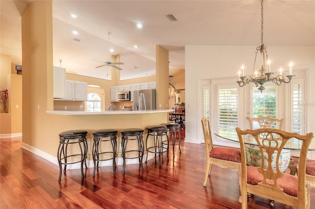 kitchen featuring stainless steel appliances, white cabinetry, a wealth of natural light, and kitchen peninsula