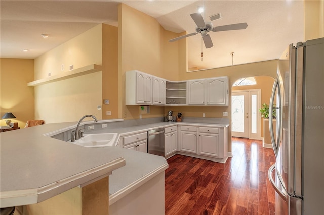 kitchen with stainless steel appliances, sink, white cabinets, and kitchen peninsula