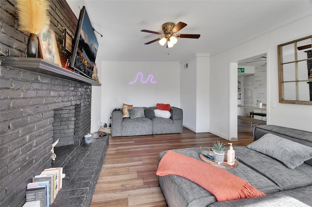 living room featuring hardwood / wood-style floors, a fireplace, and ceiling fan