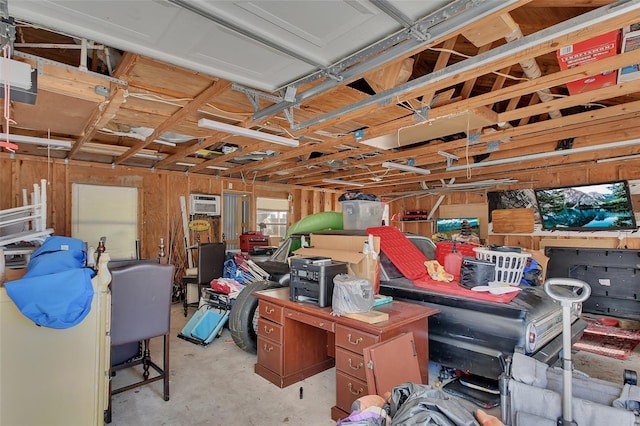 garage featuring a garage door opener and a wall unit AC